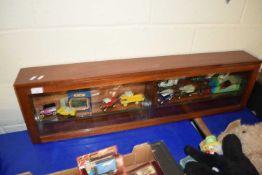 WOOD AND GLAZED DISPLAY CASE CONTAINING VARIOUS TOY VEHICLES