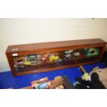 WOOD AND GLAZED DISPLAY CASE CONTAINING VARIOUS TOY VEHICLES