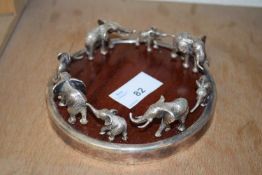 SOUTH AFRICAN SILVER PLATE AND HARDWOOD MOUNTED BOTTLE STAND DECORATED WITH A PROCESSION OF