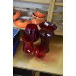 FOUR RED GLASS VASES