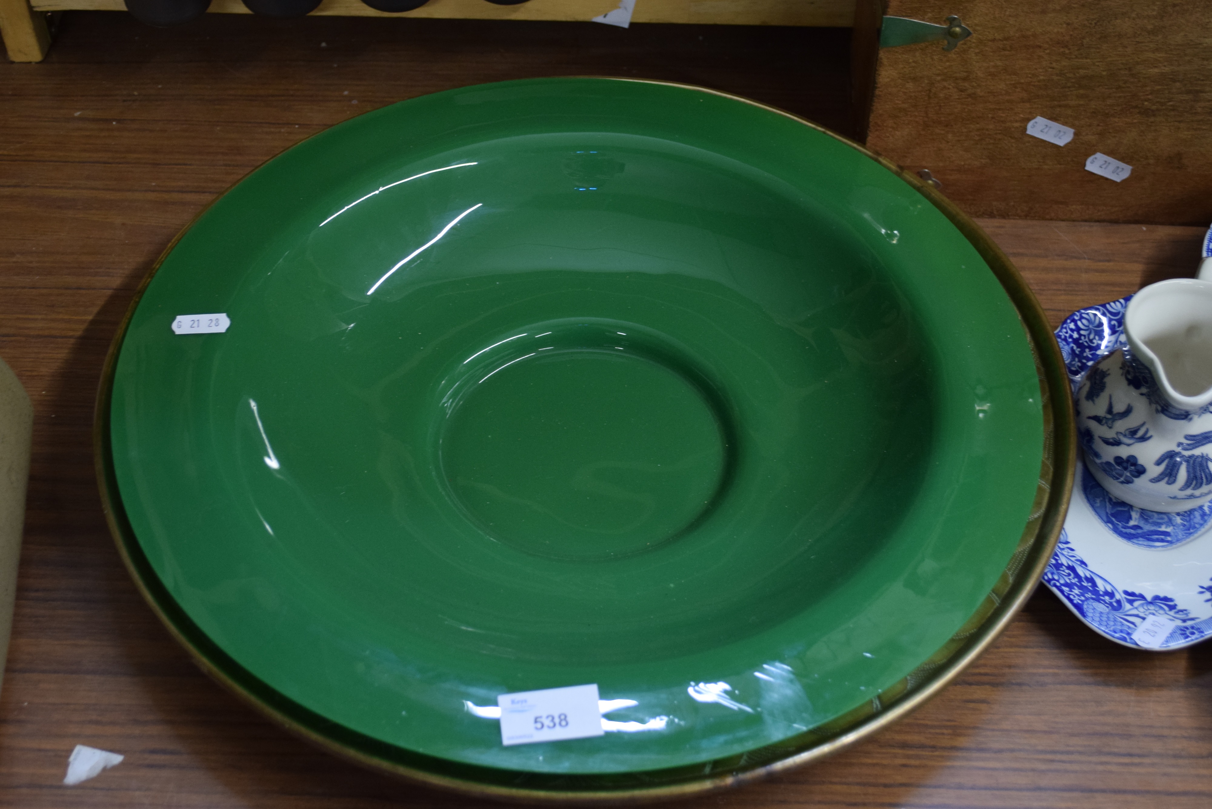 GREEN GLASS BOWL AND A FURTHER CIRCULAR BRASS TRAY