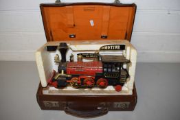 SMALL LEATHER CASE AND A BATTERY OPERATED LOCOMOTIVE