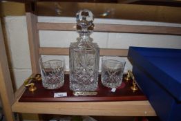 GLASS WHISKY DECANTER WITH MAHOGANY FINISH STAND AND TWO ACCOMPANYING TUMBLERS