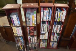 FOUR SHELVES CONTAINING VARIOUS VIDEOS AND DVDS