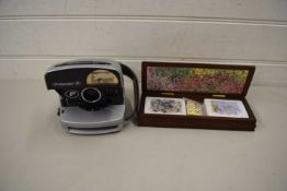 POLAROID CAMERA AND A CASED SET OF PLAYING CARDS