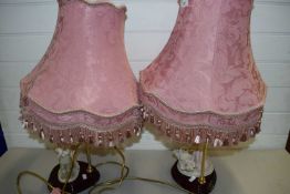 PAIR OF CAPO DI MONTE RESIN BASED FIGURAL TABLE LAMPS WITH PINK SHADES