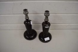 PAIR OF DARK OAK METAL MOUNTED CANDLESTICKS