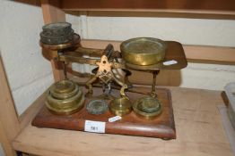 AVERY BRASS SCALES ON HARDWOOD BASE TOGETHER WITH AN ASSORTMENT OF BRASS WEIGHTS