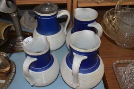 FOUR 19TH CENTURY RIBBED BLUE AND WHITE JUGS MARKED 'MILAN'