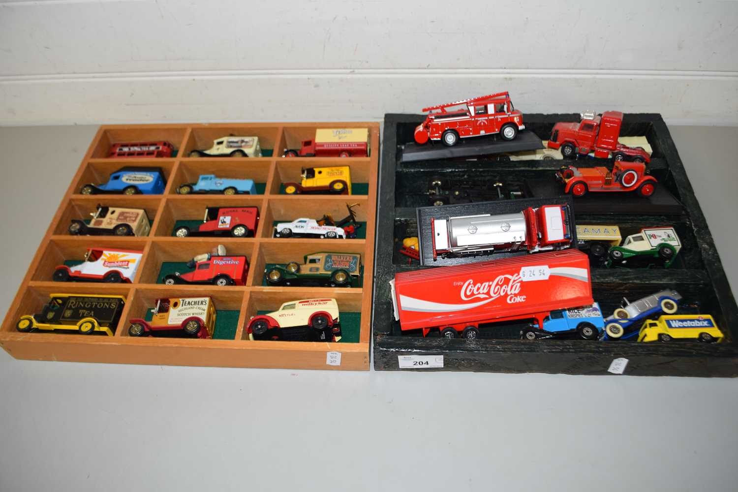 TWO DISPLAY CASES CONTAINING A RANGE OF TOY VANS, FIRE ENGINE ETC