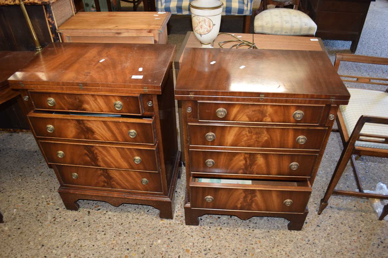 PAIR OF SMALL REPRODUCTION MAHOGANY VENEERED BACHELOR STYLE CHESTS WITH FOLD-OVER TOPS OVER FOUR