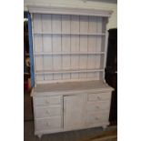 PAINTED PINE DRESSER CABINET WITH THREE SHELF BACK OVER A BASE WITH SIX DRAWERS AND ONE PANELLED