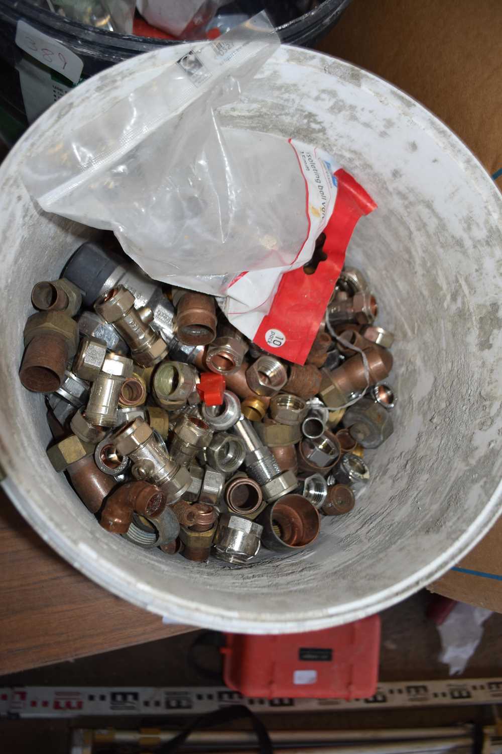 Bucket containing various connectors, isolating ball valves etc