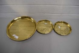 TWO BRASS WARE DISHES AND A LARGER DISH, ALL WITH ORIENTAL DESIGNS