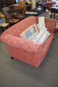RED UPHOLSTERED TWO-SEATER SOFA