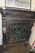ORNATELY DECORATED OAK CABINET WITH STAINED GLASS DOORS