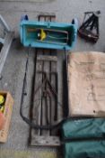 Rotary garden seeder together with a sprinkler and a collapsible vintage bench