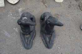 Two identical garden statues modelled as dogs, height approx 30cm, length approx 60cm