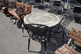 Cast decorative garden table with four chairs, table height 70cm