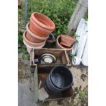 Large quantity of plastic and terracotta plant pots