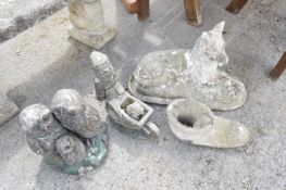 Four composite garden statues - family of owls, boot, gnome with wheelbarrow etc