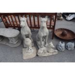 Four composite garden statues, two hounds, an owl on a plinth and an Alsatian dog, tallest 88cm (