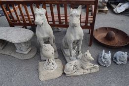 Four composite garden statues, two hounds, an owl on a plinth and an Alsatian dog, tallest 88cm (