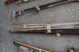 Bundled quantity of bamboo canes, longest 180cm, together with a small roll of roofing felt and a