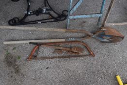 Heavy duty post hole diggers, together with a bow saw and a vintage chain wrench