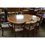 REPRODUCTION MAHOGANY AND CROSS BANDED OVAL DINING TABLE TOGETHER WITH A SET OF EIGHT REPRODUCTION