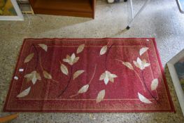 SMALL FLORAL DECORATED RED RUG, 150CM LONG
