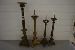 THREE BRASS PRICKET STYLE CANDLESTICKS AND A FURTHER TABLE LAMP BASE (4)