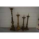 THREE BRASS PRICKET STYLE CANDLESTICKS AND A FURTHER TABLE LAMP BASE (4)