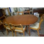 REPRODUCTION OVAL EXTENDING DINING TABLE ON FLUTED LEGS TOGETHER WITH A SET OF SIX SABRE LEG