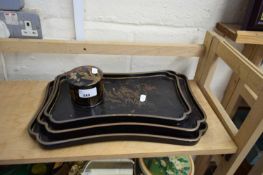 GRADUATED SET OF THREE ORIENTAL BLACK LACQUERED TRAYS AND A FURTHER SIMILAR COVERED POT (4)