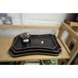 GRADUATED SET OF THREE ORIENTAL BLACK LACQUERED TRAYS AND A FURTHER SIMILAR COVERED POT (4)
