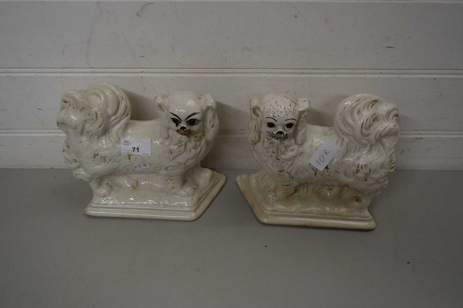 PAIR OF STAFFORDSHIRE POODLE TYPE DOGS WITH WHITE AND GILT DECORATION