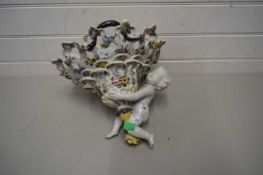 Continental ceramic lamp, the shade supported by a large cherub, lamp with floral design