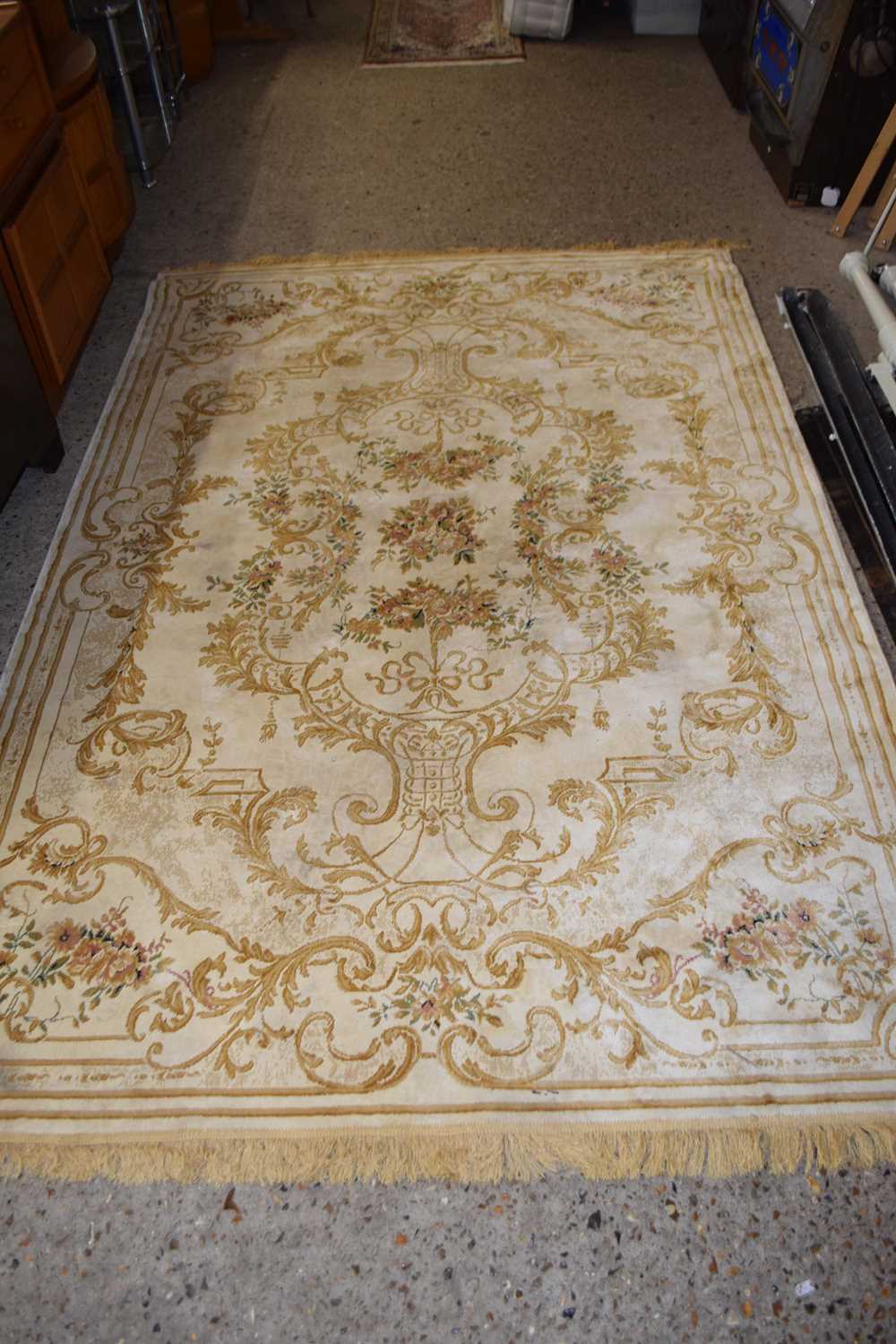 LARGE RUG WITH FLORAL DESIGN ON BEIGE GROUND (Pleae note VAT is to be added on hammer price for this