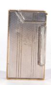 Vintage Dunhill petrol lighter in Art Deco taste with silvered and gilt metal case (no hallmarks),