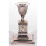 Edwardian period single loaded base candlestick with fluted square column and integral sconce,