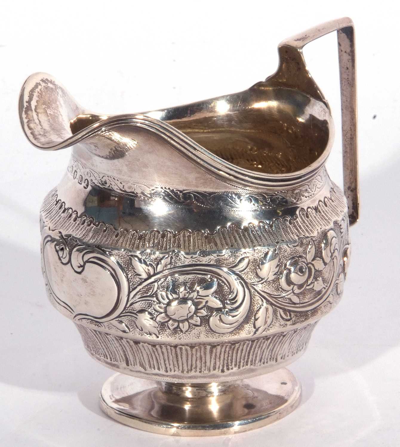 George III large baluster cream jug with reeded rim and angular handle, plain circular foot, later