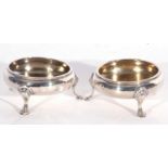 Pair of George III circular gilt lined salts with lightly gadrooned rims supported on three hoof