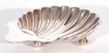 Edwardian butter shell of typical form, resting on three ball feet, 13.5cm x 10cm maxs, London
