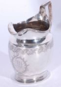 Good George III helmet cream jug, having reeded rim, foot and handle, engraved foliate and medallion
