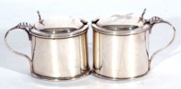 Small pair of George V drum mustards with looped handles, hinged lids, complete with blue glass
