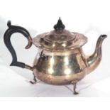 George V teapot of circular baluster form with shaped rim, ebonised handle and finial, supported