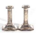 Pair of George V silver encased dressing table candlesticks of canted square form with sealed loaded