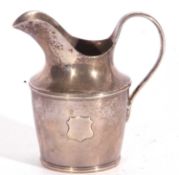 Antique silver cream/milk jug of tapering cylindrical form with solid looped handle, probably