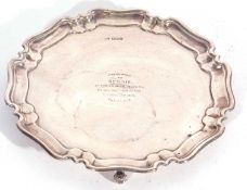 George V silver card salver, applied with a Chippendale border supported on four scroll feet